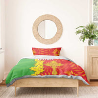 Eritrean bedding set on bed with red pillow cases and green comforter with yellow ERITREA text