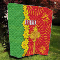 Folded quilt with green quilted field, red folk print, yellow floral details, 'ERITREA'