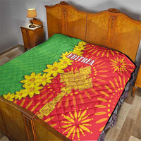 Quilt on bed with green cover and red folk design, yellow floral trim, 'ERITREA' 