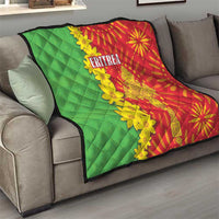Red and green quilt over couch with yellow floral folk pattern and 'ERITREA' title
