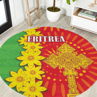 Round folk-pattern carpet with green, red, and yellow floral design and ERITREA text