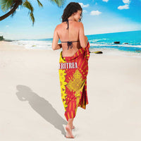 Red, yellow and green Eritrea sarong with ornate central emblem and floral pattern