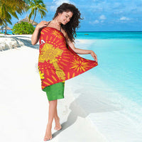 Red dashiki sarong with yellow flower and sunburst designs and green border
