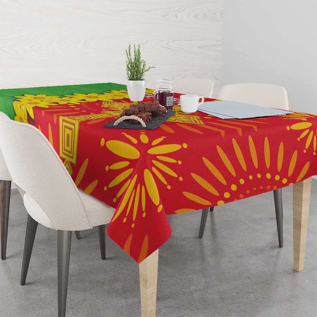Red folk-pattern tablecloth with green panel and yellow sunburst floral motifs