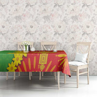 Folk-pattern tablecloth in red, green, and yellow with bold geometric and flower details