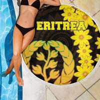 Round beach blanket with fringe, ERITREA text, yellow flowers and green tree on dark base