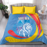 Aruba bedding set on bed: blue duvet with lion emblem and ARUBA lettering, paired yellow pillows