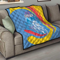 Aruba quilt blanket on sofa, roaring lion image, ARUBA text, blue base with yellow red swirls