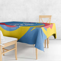 Blue, yellow, and red printed tablecloth with roaring lion and crest pattern