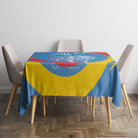 Blue, yellow, and red lion crest tablecloth on a dining table