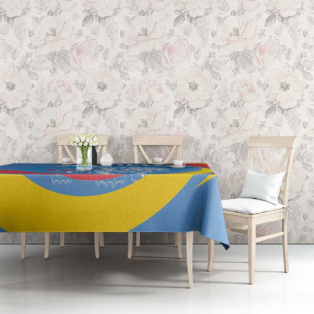 Blue, yellow, and red printed tablecloth covering a dining table