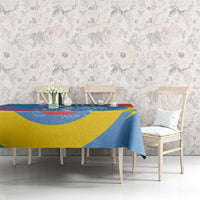 Blue, yellow, and red printed tablecloth covering a dining table