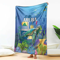 Blue blanket featuring ARUBA logo, sea turtle, ocean plants and waves