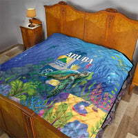 Blue sea turtle quilt laid on bed, ARUBA text and colorful underwater landscape print