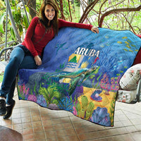 Blue sea turtle quilt draped over seat, ARUBA text and underwater landscape print