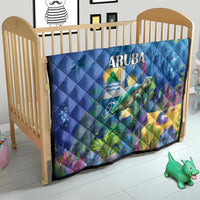 Blue sea turtle quilt on crib with ARUBA text and underwater coral reef design