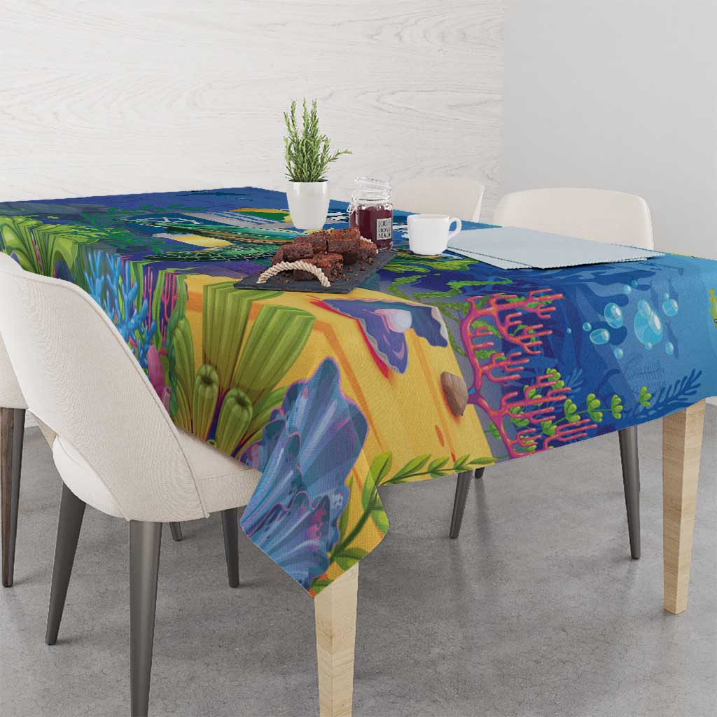 Blue sea turtle tablecloth draped over table with colorful underwater landscape print
