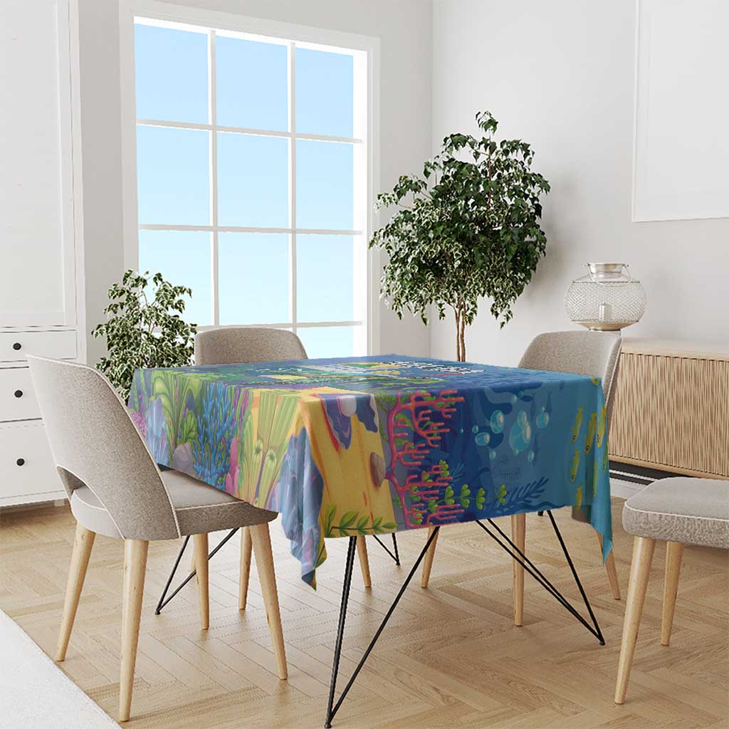 Blue sea turtle tablecloth on table with underwater reef, fish, and plant illustration