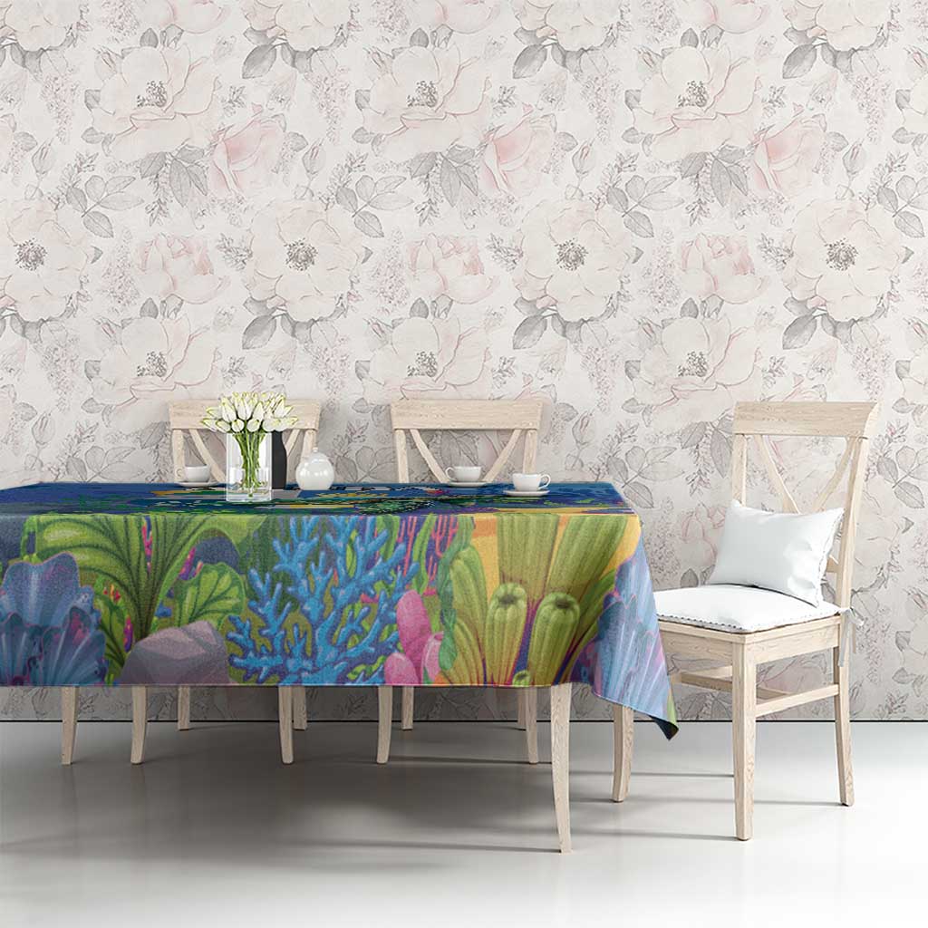 Blue sea turtle tablecloth over dining table with underwater scene in bright colors