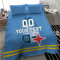 Blue bedding set with pillows; duvet shows '00 YOUR TEXT' and red star emblem