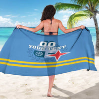 Blue sarong with crest and red star graphic, draped back view with tied top