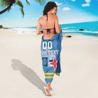 Blue custom sarong with crest and red star, hanging to mid-calf length