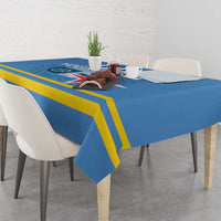 Blue tablecloth with yellow stripe edge and flag-style crest in center, draped to sides