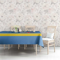 Blue tablecloth with yellow border stripe and red star crest graphic on a dining table