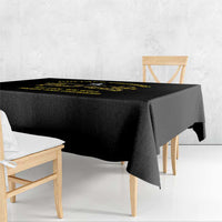 Black tablecloth with yellow graphic text running along the top edge
