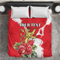 Red personalized bedding set with lion crest, roses, white pattern, and two white pillows