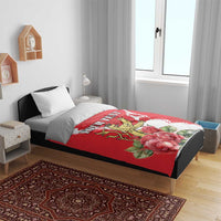 Red personalized duvet on bed with lion crest and roses, paired with white pillows