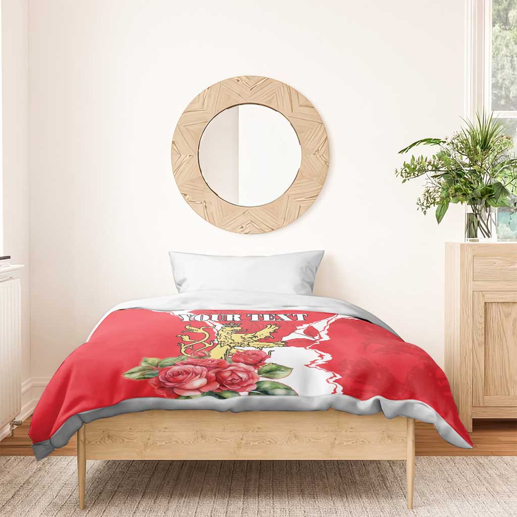 Red personalized duvet cover with lion crest, roses, and white pattern on wooden bed
