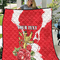 Red and white quilt with quilted pattern, lion crest, roses, and personalized text area.