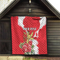 Red quilted quilt blanket with lion crest, roses, and personalized text on a wooden backdrop.