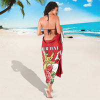 Red personalized sarong with lion crest, roses, and 'Your Text' lettering from behind