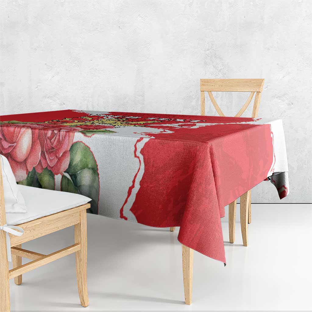 Red floral tablecloth draped over dining table corner, white border pattern