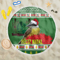 Green circular beach blanket with white fringe, bird and “FELIZ NATAL” holiday print