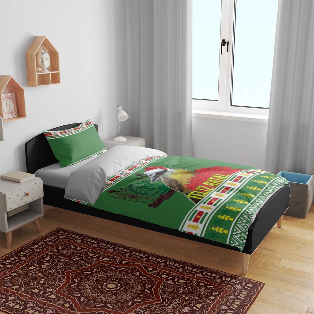 Green Feliz Natal comforter with bird print and festive stripe border on bed with pillows