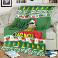 Green throw blanket on couch with bird and red Santa hat, Feliz Natal banner and patterns