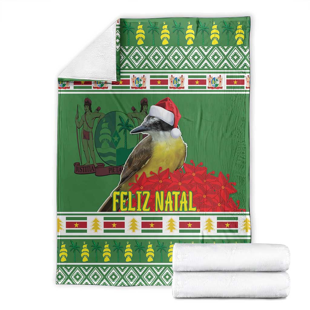 Green Christmas throw blanket folded with bird and red Santa hat, Feliz Natal and festive trim