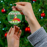 Green round ceramic Christmas ornament held in hands, with kiskadee bird and Feliz Natal