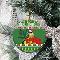 Green round ceramic ornament with kiskadee bird and Feliz Natal, hanging on tree