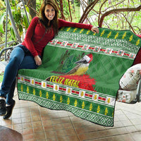 Green Christmas quilt with bird artwork, red “Feliz Natal” strip, and yellow-green ornament pattern.