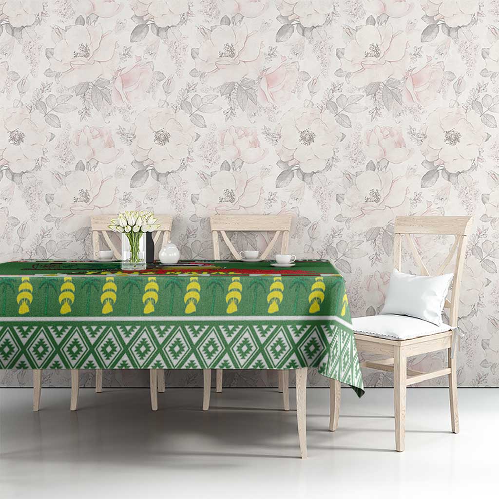 Green tablecloth with repeating leaf and diamond patterns along the center, on dining table