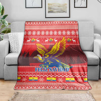 Red Feliz Navidad blanket with Andean condor graphic and festive border pattern