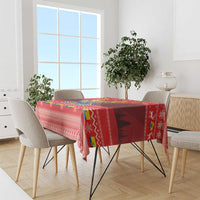 Red Christmas tablecloth with Andean condor scene, decorative band, and geometric motifs