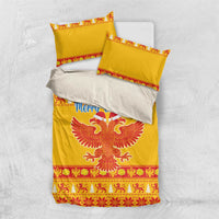 Yellow Christmas bedding set laid flat: duvet with eagle graphic, two matching pillowcases