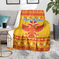 Yellow Christmas blanket spread on a chair, showing Merry Christmas text and red double-headed eagle.
