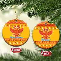Yellow ceramic double-headed eagle Christmas ornament, round with red pattern and 'Merry Christmas'