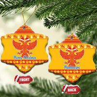 Yellow ceramic double-headed eagle Christmas ornaments, bell-shaped with red pattern and 'Merry Christmas' and 'Montenegro'